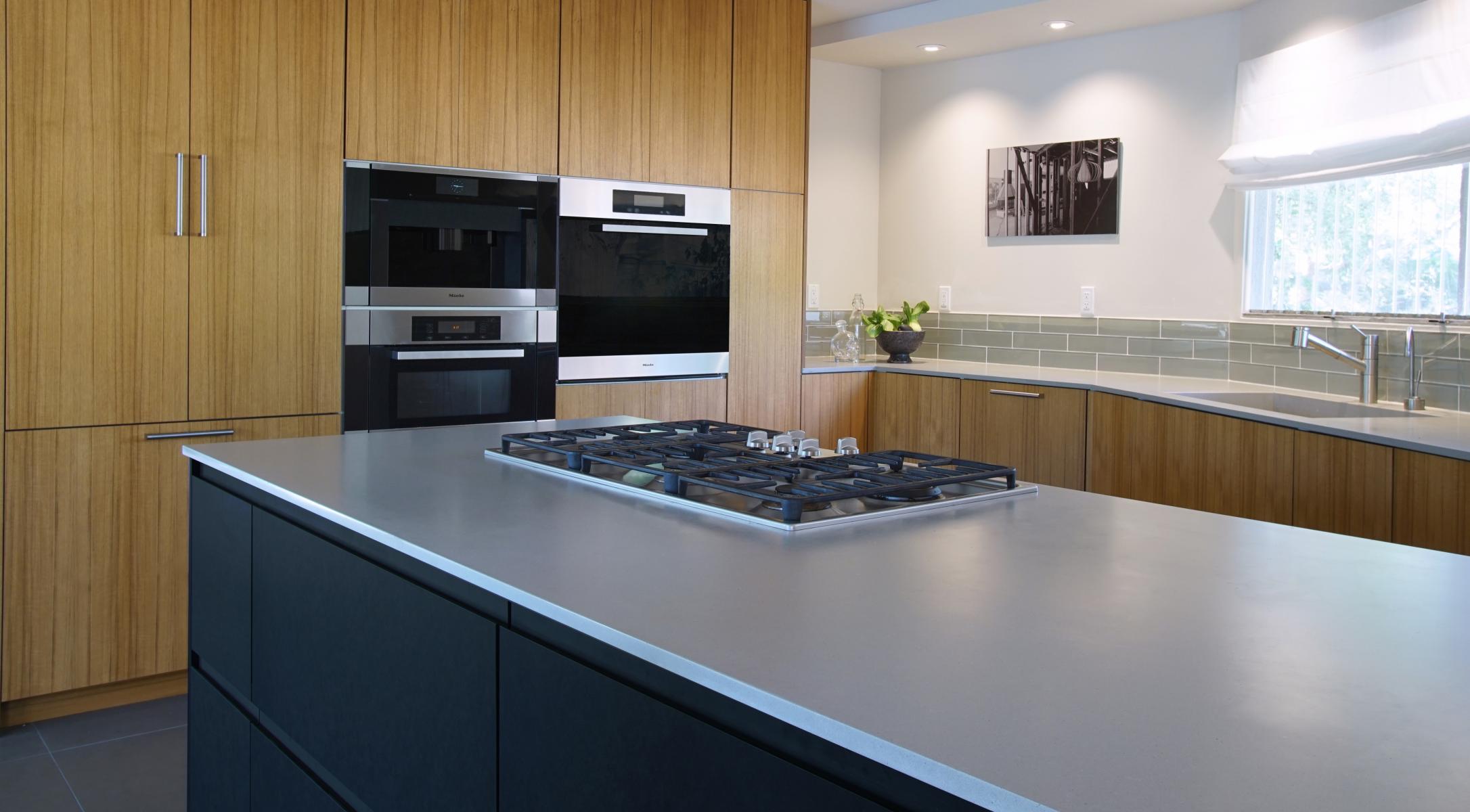 dCabinets custom Teak and black Phenolic with integrated pulls over IKEA cabinets